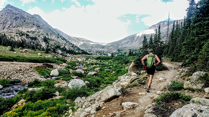 Trail Runner Doing Altitude Training In The Mountains Using A Pulse Oximeter