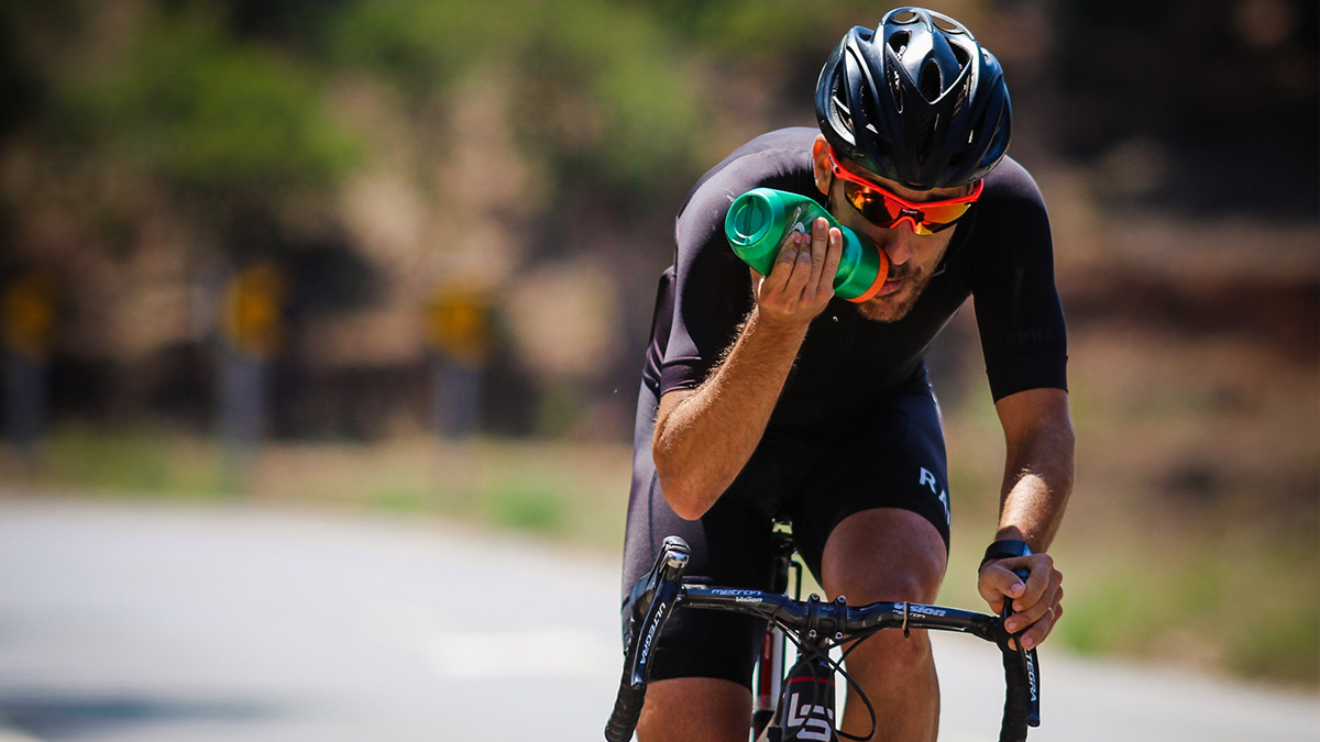 Image Of A Male Cyclist On Bicycle Drinking Water During Periodization Training