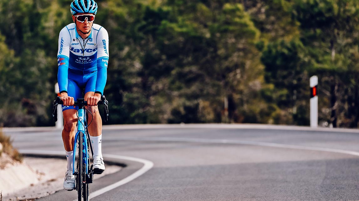 Cyclist Riding Down Road