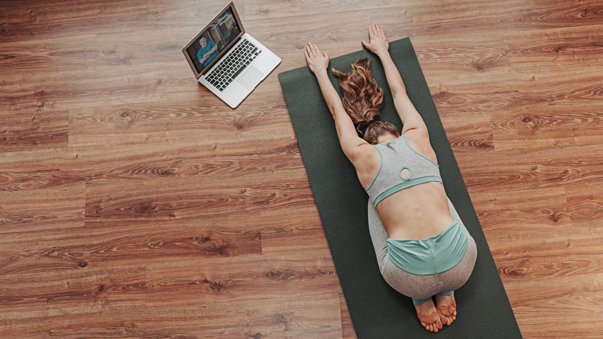 Young Lady Doing Child’s Yoga Pose At Home