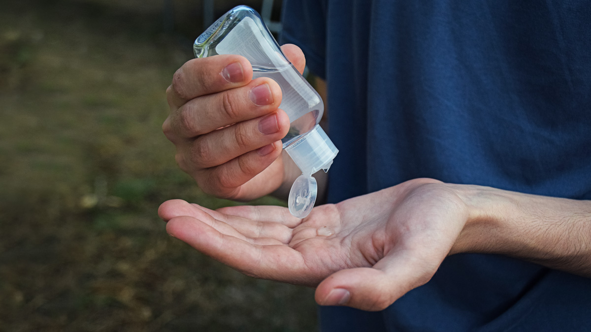 A Small Hand Sanitizer Bottle Being Used To Protect Against Viru