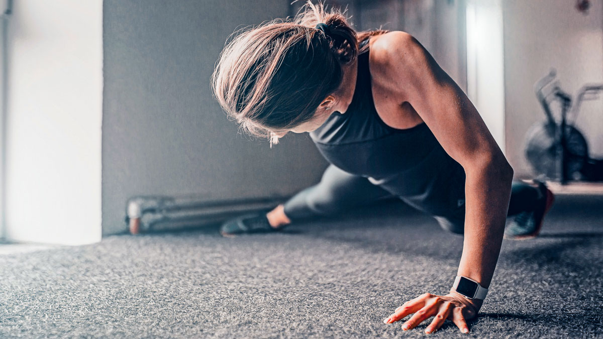 Strong Athletic Slim Woman Performs Push Ups On The Floor On One Arm