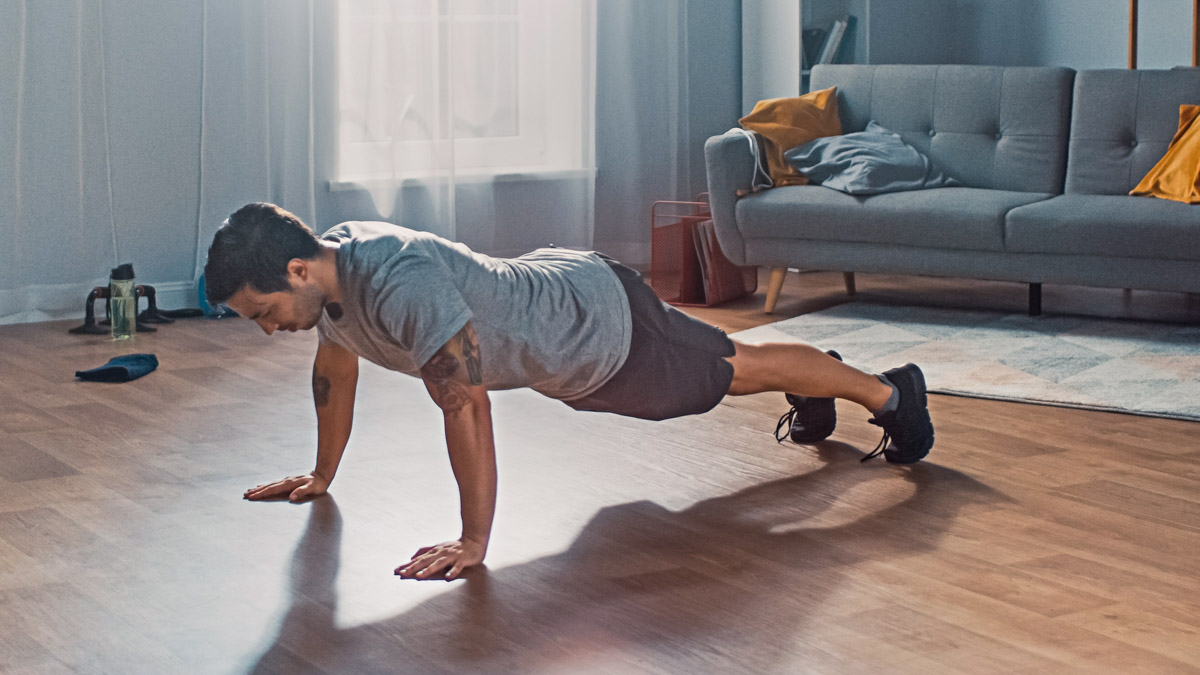 Muscular Athletic Fit Man In T Shirt And Shorts Is Doing Push Up