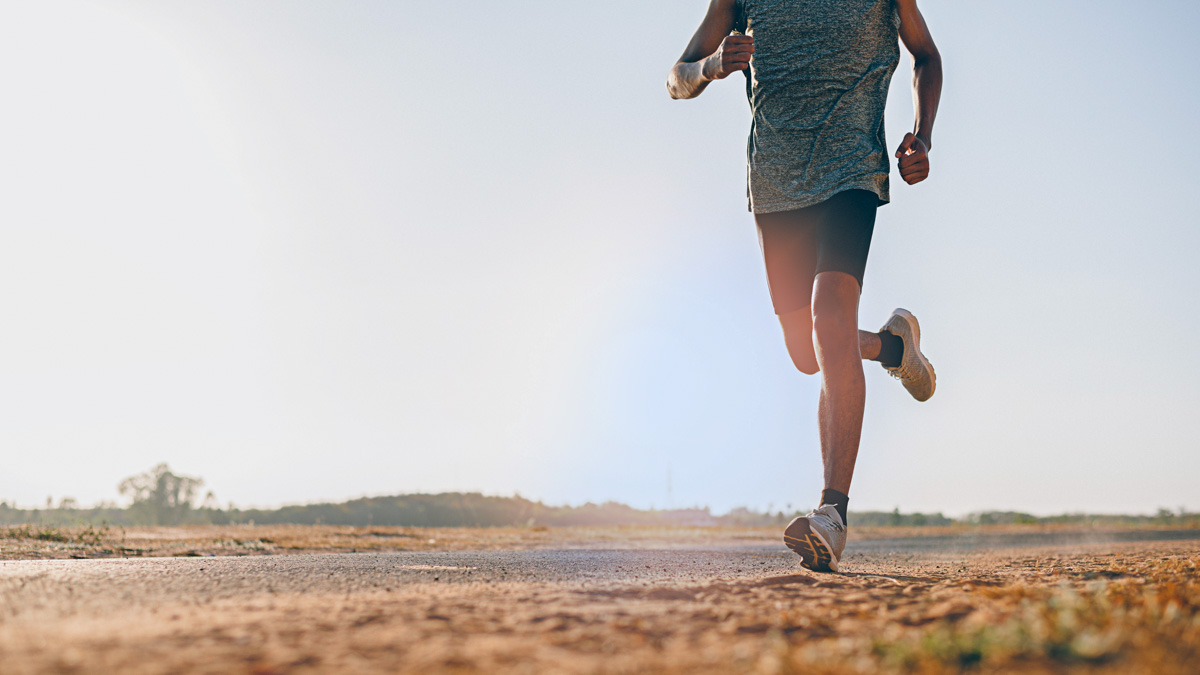 Athlete Runner Feet Running On Road, Jogging At Outdoors. Man Ru