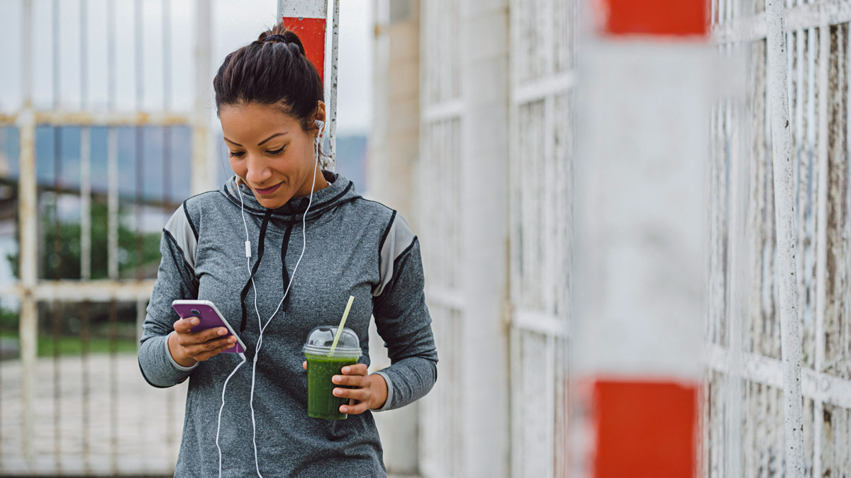 Urban Fitness Woman Texting On Her Smarphone