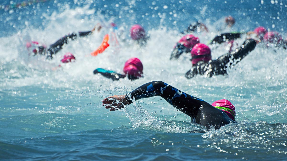 Group People In Wetsuit Swimming At Triathlon