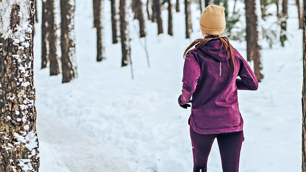 Sports Girl Runs In The Winter In The Forest. Active Way Of Life All Year Round