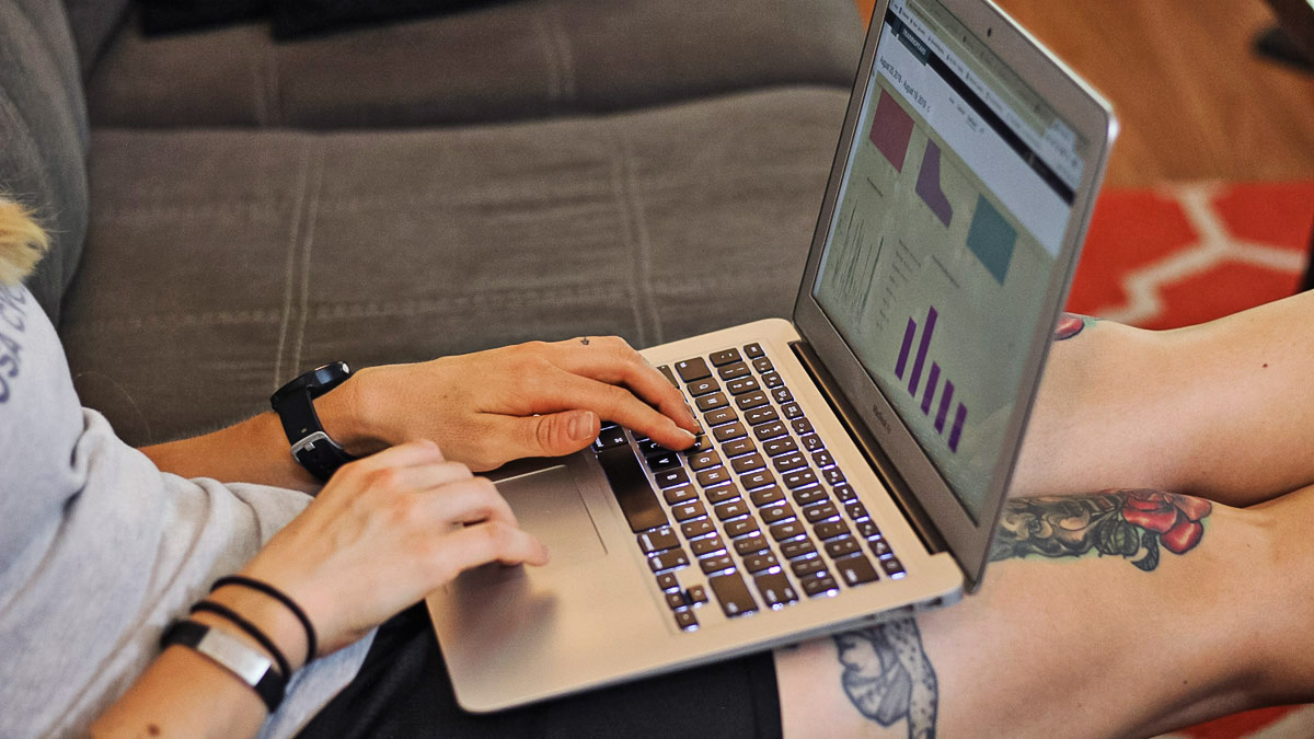 Image Of A Woman On Her Computer Using Trainingpeaks Software To Implement Block Periodization Into Her Training