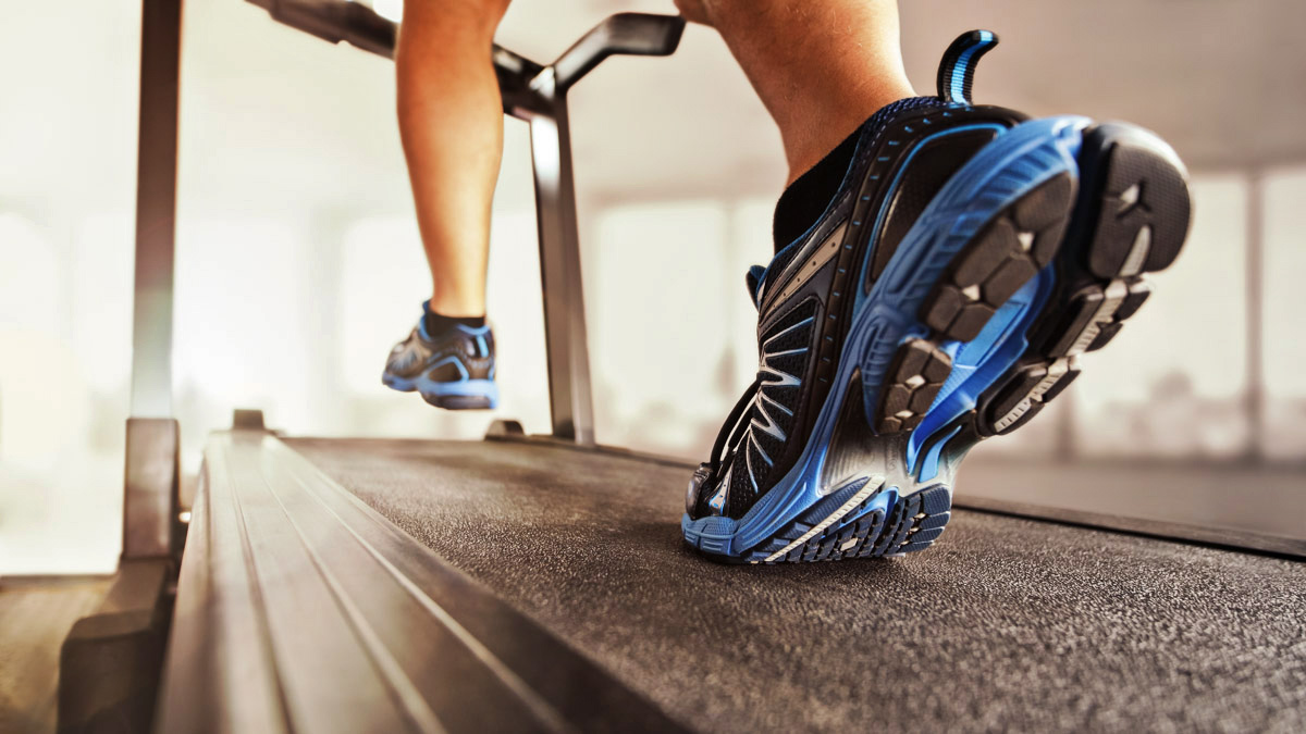 Image Of A Runner's Feet And Shoes Running On A Non Motorized Treadmill