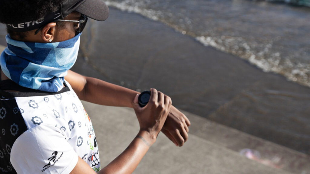 A woman looking at her running watch