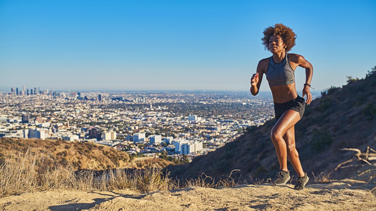 Fit African American Woman Running At Runyon Canyon With Los Ang