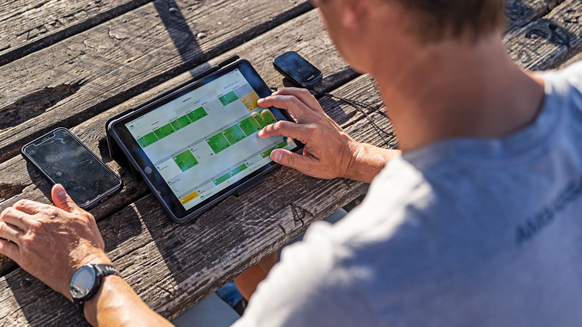 Trainingpeaks Ambassador Uses The Trainingpeaks App On A Tablet Outside On A Picnic Table