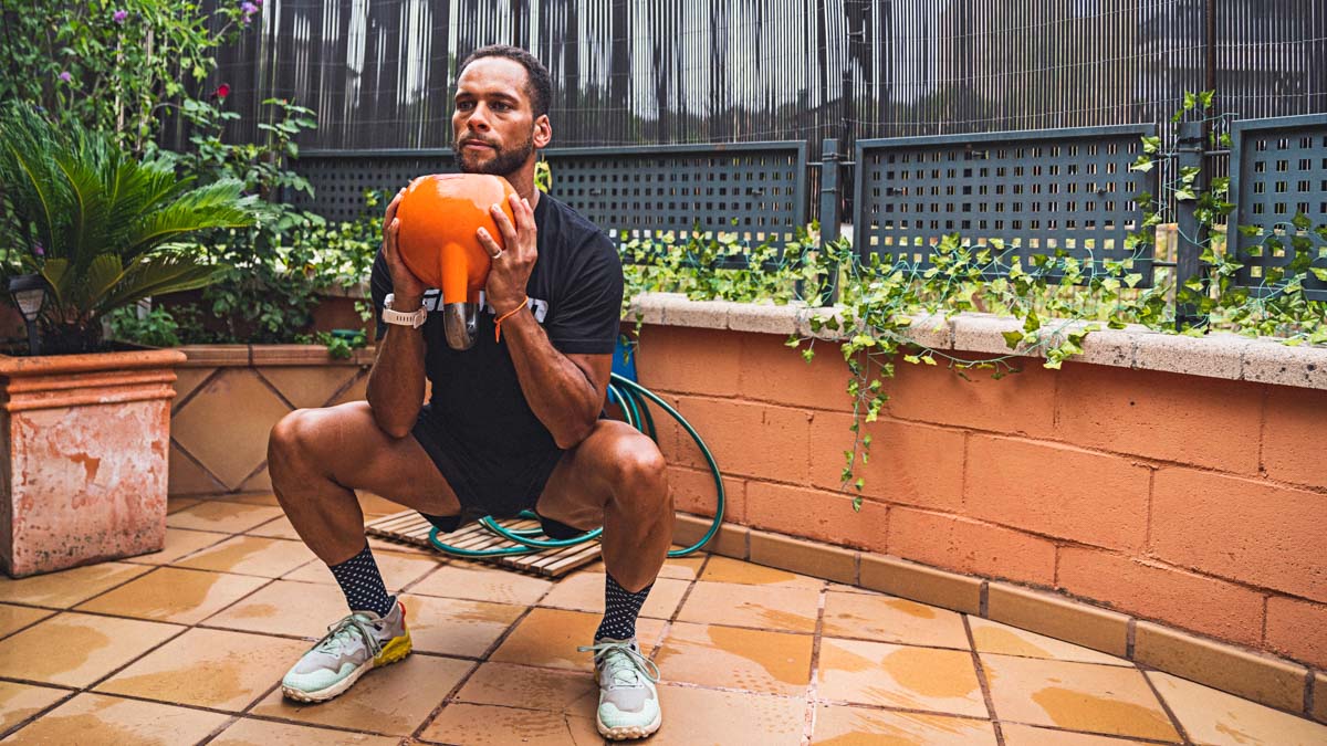 Fit Black Man Doing A Goblet Squat During A Training Session.