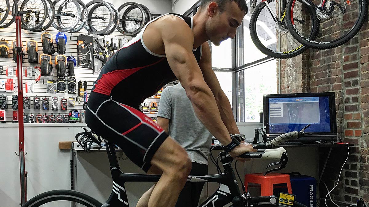 Triathlete On Indoor Trainer Bike Focusing On Winter And Spring Training For Triathlon