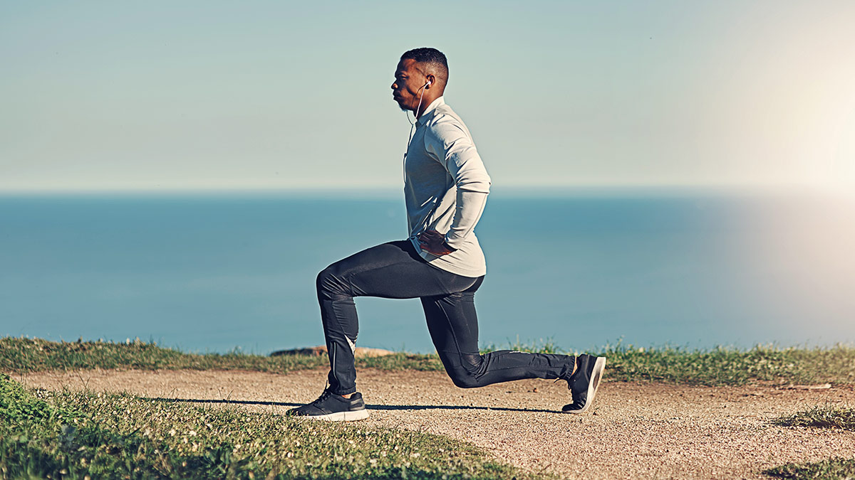 Endurance Athlete Outdoors Warming Up For Strength Training By Doing A Lunge