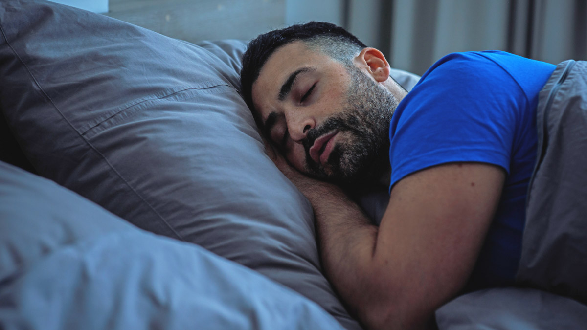 Image Of A Man Sleeping In Bed After Implementing Strategies That Taught Him How To Fix Circadian Rhythm