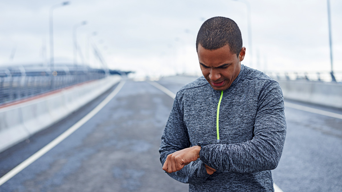 Image Of A Male Runner Looking At His Running Watch To Check His Heart Rate