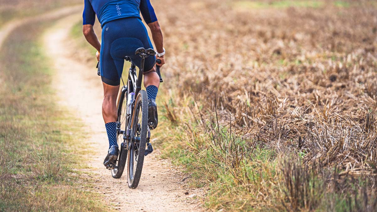 Athlete Riding On Gravel Trail