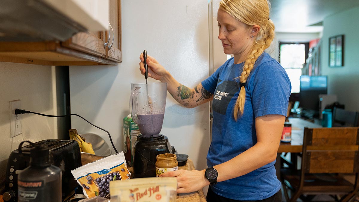 A Woman In Her Kitchen Mixing A Smoothie For A Post Ride Meal