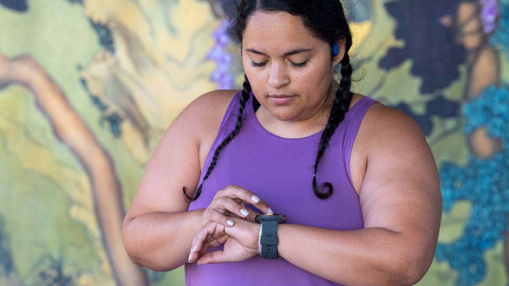 a woman looking at her wearable device measuring her heart rate for HRV tracking