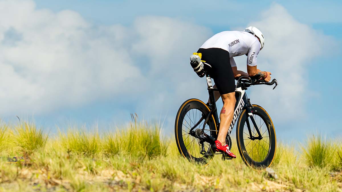 A Male Cyclist Rides A Time Trial Bike On A Road