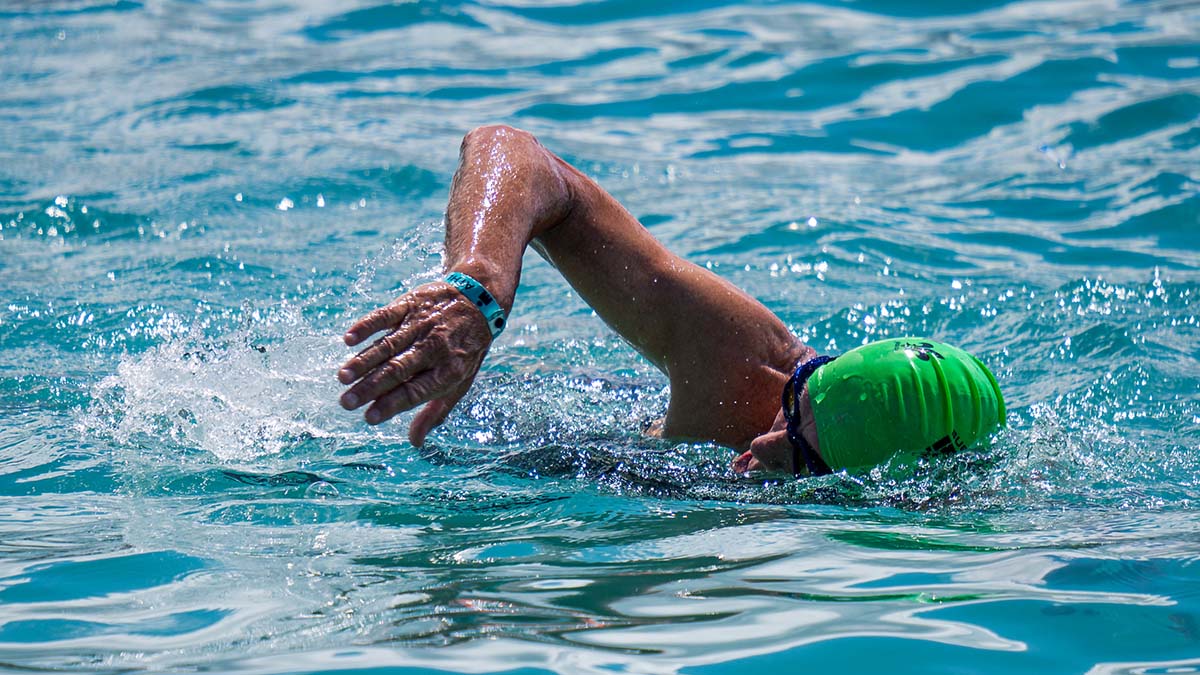 A Male Triathlete Swimming In The Ocean Off Kona, Hawaii.