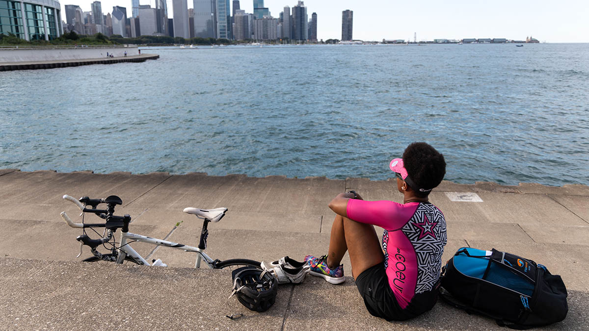 A Woman Triathlete Looking At Downtown Chicago While Taking A Break On The Lakeshore Path