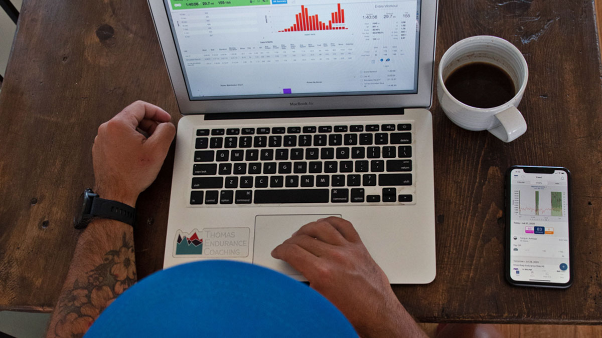 An Endurance Coach Evaluates Data In The Trainingpeaks App At A Desk