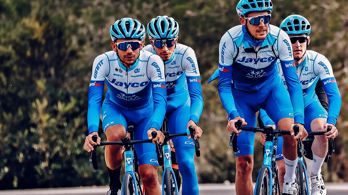 Cycling Team Riding Through The Mountains