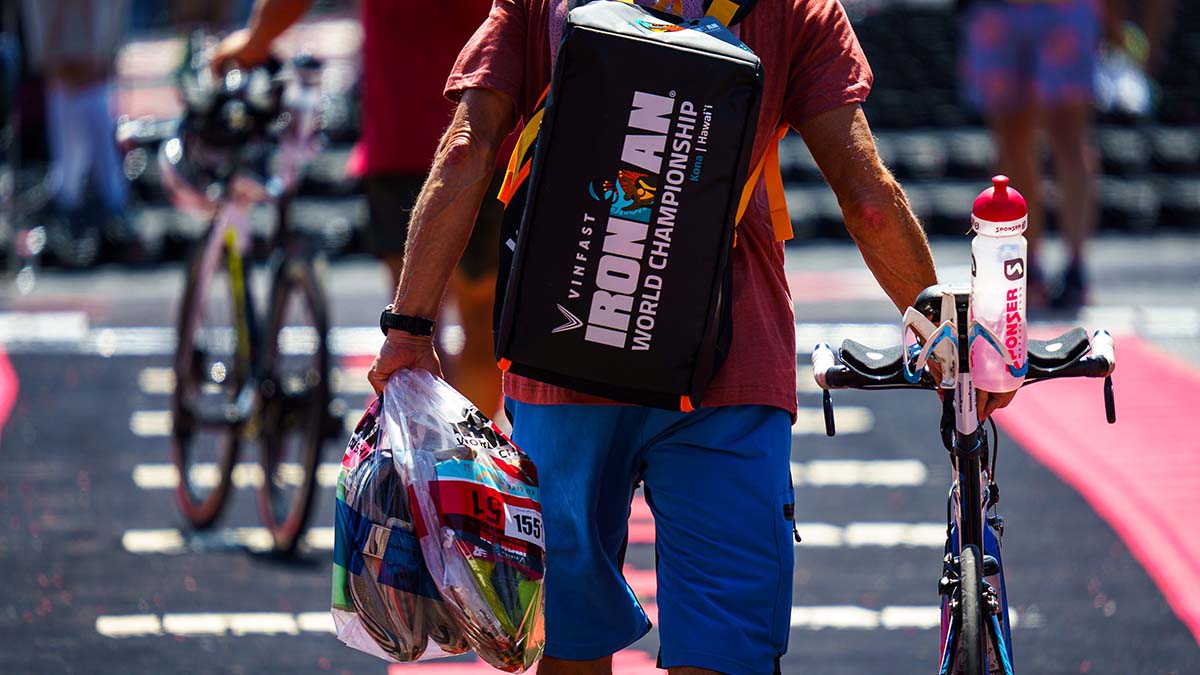 A Triathlete Taking His Bike And Drop Bags Into The Transition Area For The Kona World Championships