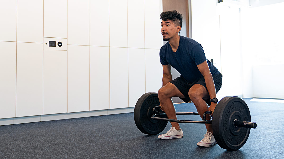 Male Runner Performing Squat During Strength Training