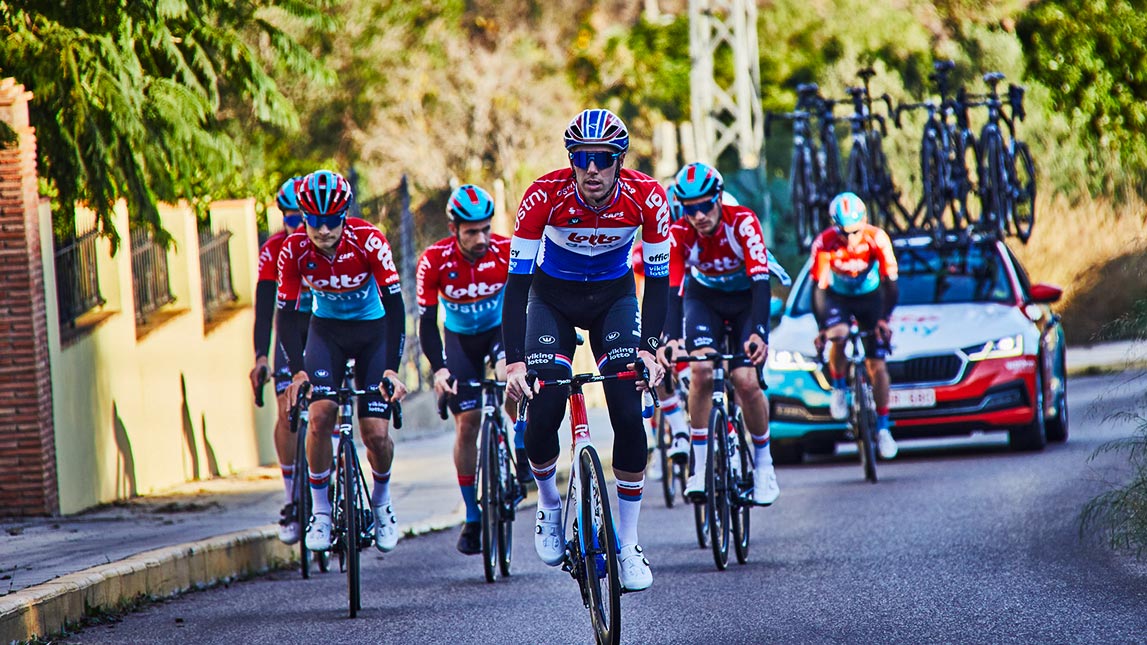 Professional Cycling Team Riding Up Road