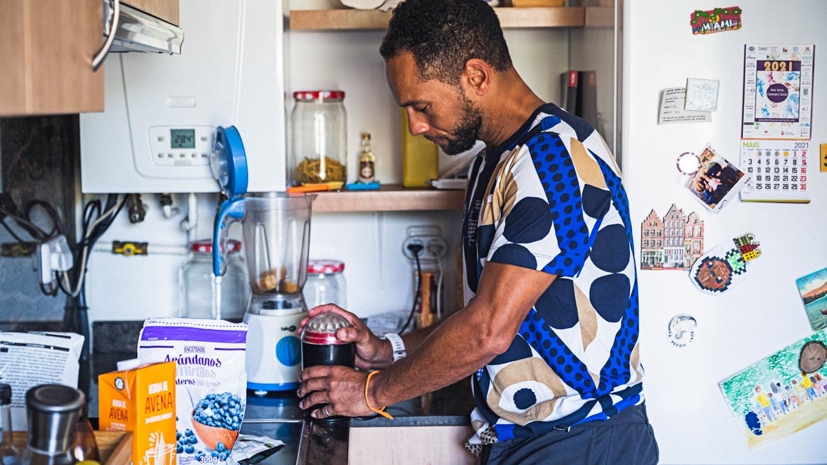 A Black Man Making A Smoothie Meal In His Kitchen