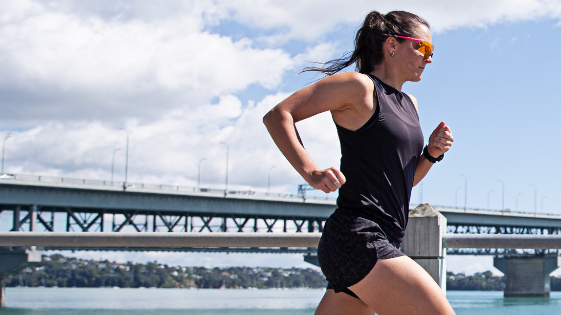 Female Athlete Running Across A Bridge