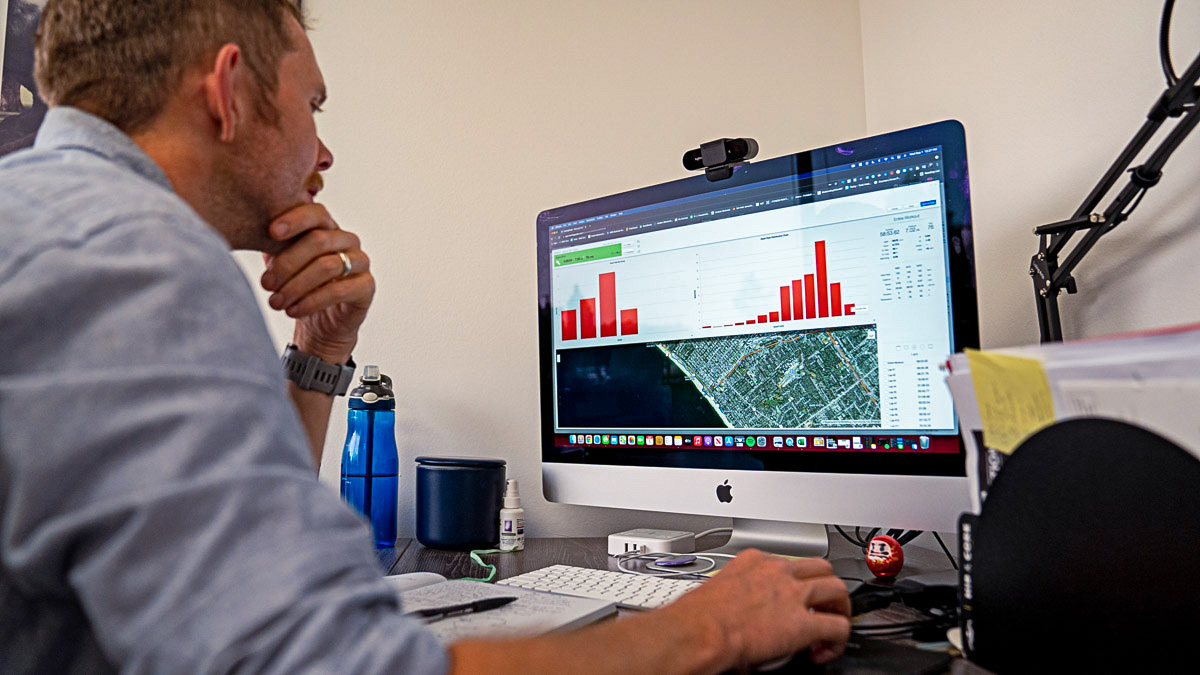 A Man Working At A Desktop Computer Using Trainingpeaks To Evaluate A Workout