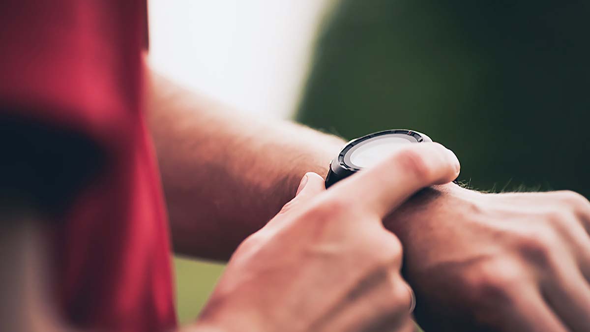 Detail Photo Of An Athlete's Hands Operating A Running Watch